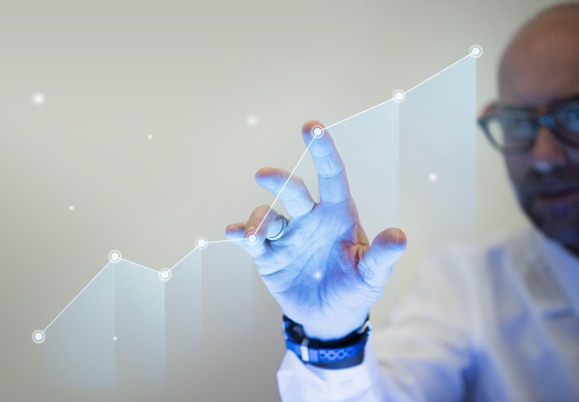 Businessman pointing his finger to a growth graph