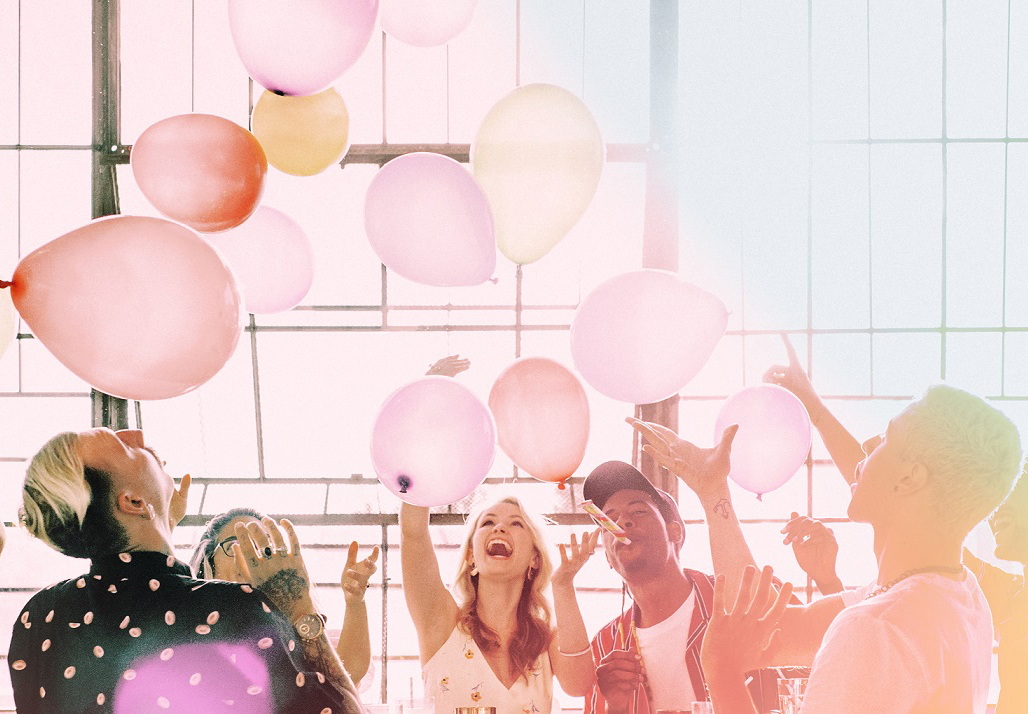 People playing with balloons at a party wallpaper